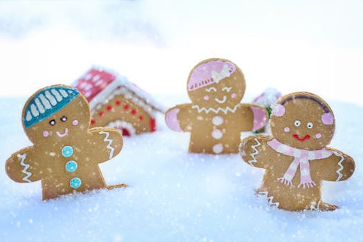 Three gingerbread figures in snow, celebrating a cheerful winter season.